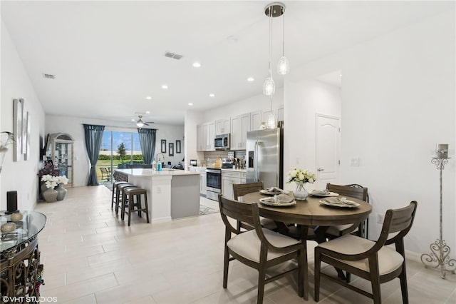 dining space featuring ceiling fan