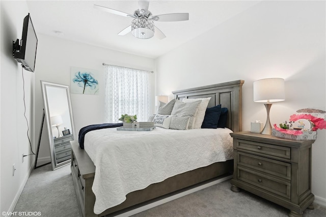 bedroom featuring light carpet and ceiling fan