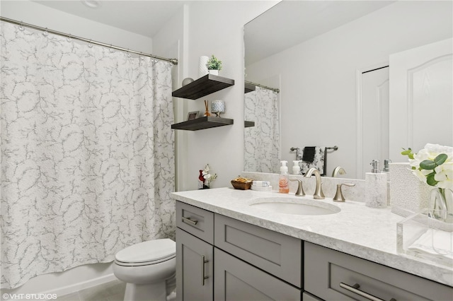 full bathroom with vanity, shower / tub combo, and toilet