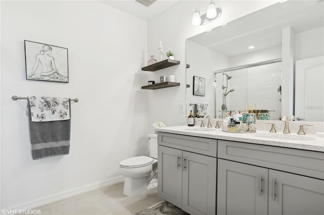 bathroom featuring vanity, toilet, and a shower with door