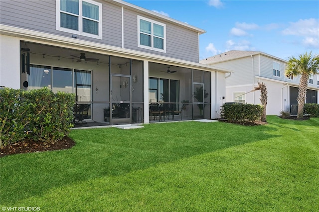 rear view of property with a sunroom, a yard, and ceiling fan