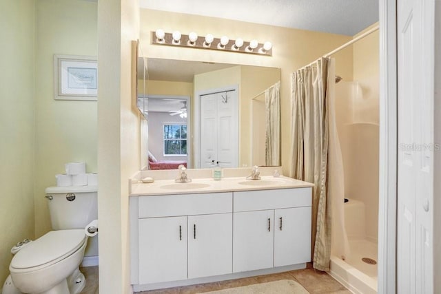 bathroom featuring toilet, vanity, tile patterned floors, and a shower with curtain