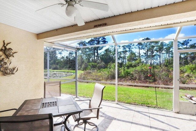 sunroom / solarium with a wealth of natural light and ceiling fan