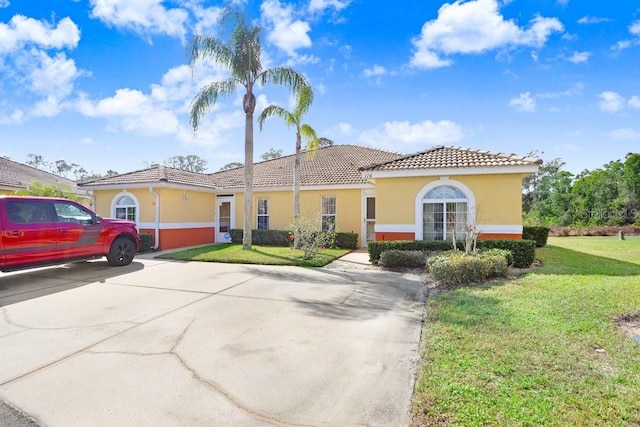 mediterranean / spanish-style house with a front yard