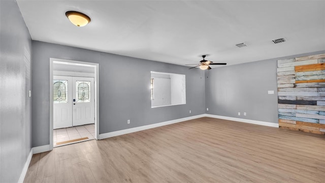 interior space featuring light hardwood / wood-style floors, french doors, and ceiling fan