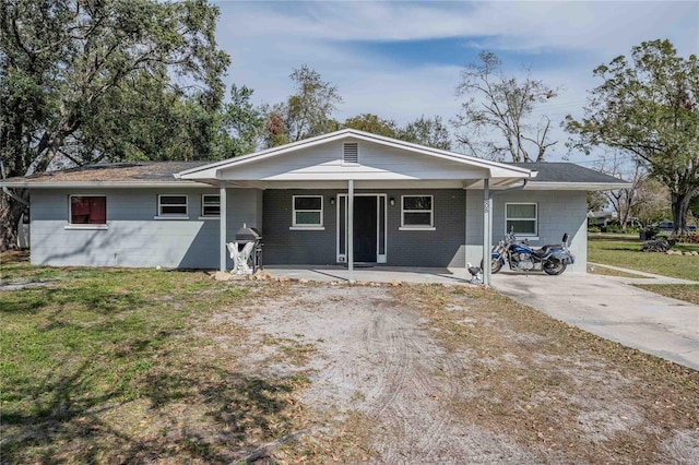 ranch-style house with a front lawn and covered porch