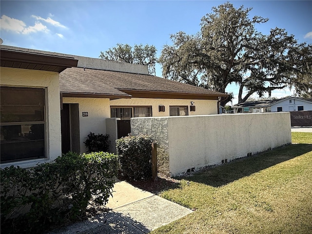 view of home's exterior with a lawn