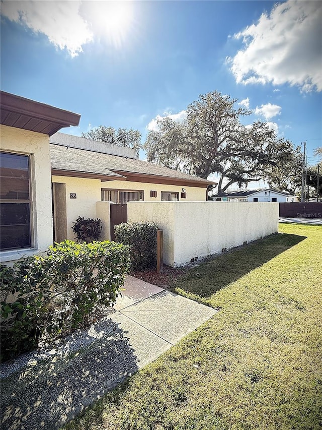 view of side of home featuring a lawn