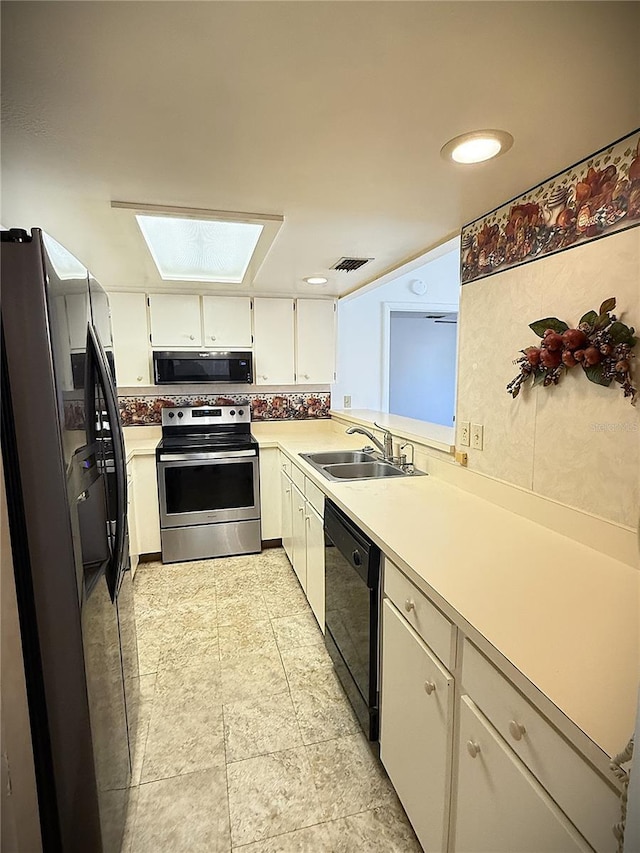 kitchen featuring backsplash, stainless steel appliances, sink, and white cabinets