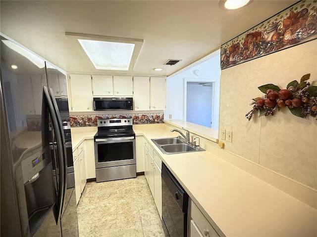 kitchen featuring white cabinetry, sink, and black appliances