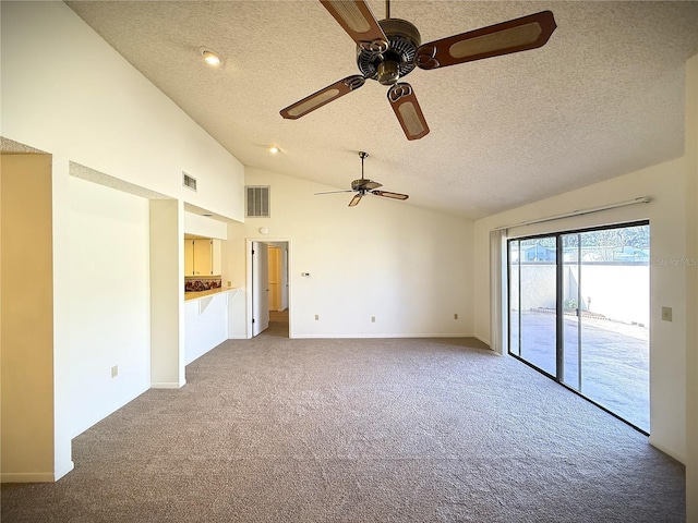 unfurnished living room with carpet, high vaulted ceiling, and a textured ceiling