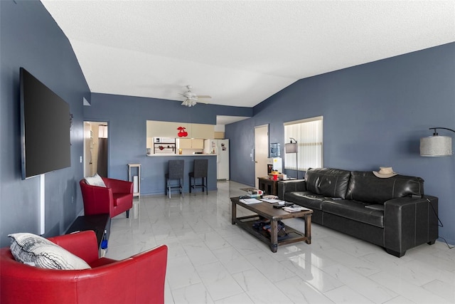 living room featuring lofted ceiling, a textured ceiling, and ceiling fan