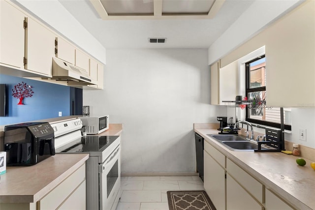 kitchen with white appliances, cream cabinets, and sink