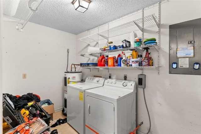 clothes washing area featuring washing machine and clothes dryer, electric panel, electric water heater, and a textured ceiling