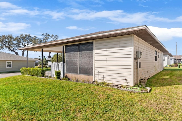 view of side of home featuring a lawn