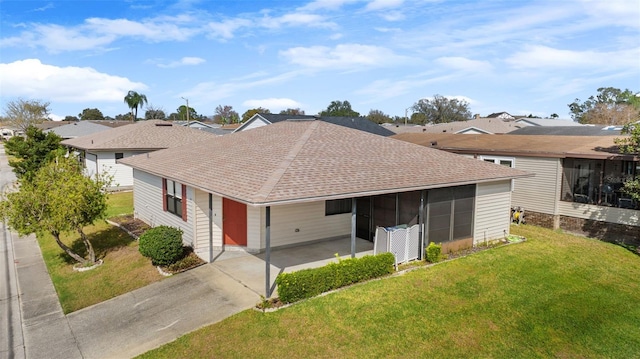 ranch-style house with a front yard and a carport