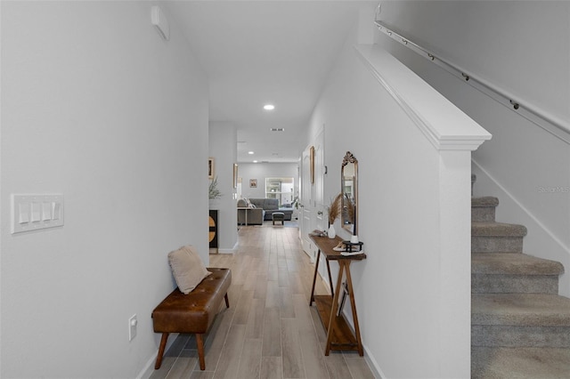 hall with hardwood / wood-style floors