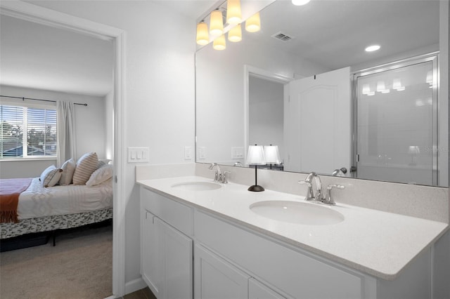 bathroom with a shower with door and vanity