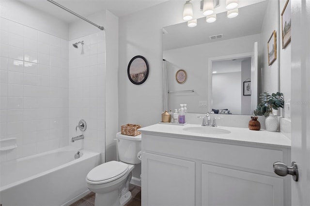 full bathroom featuring vanity, toilet, and tiled shower / bath combo