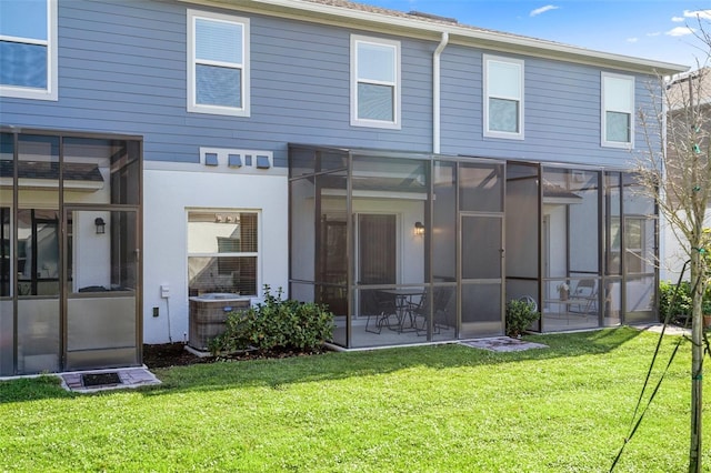 back of house with a patio area, central air condition unit, and a lawn