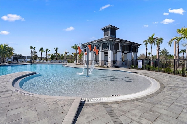 view of swimming pool with pool water feature