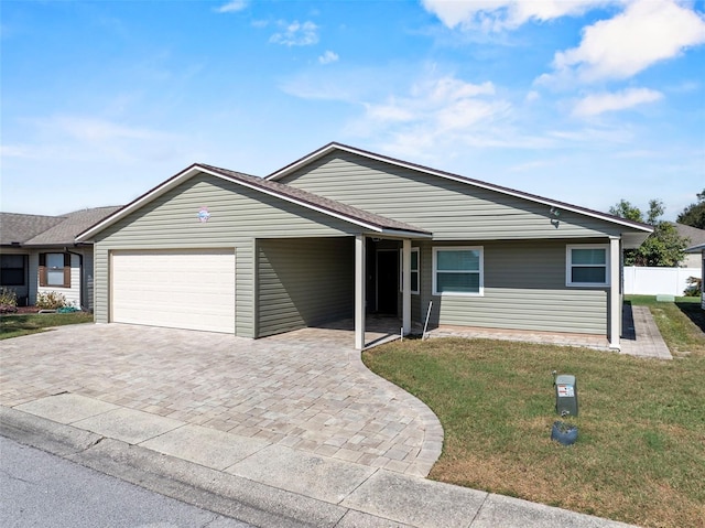 single story home with a garage and a front lawn