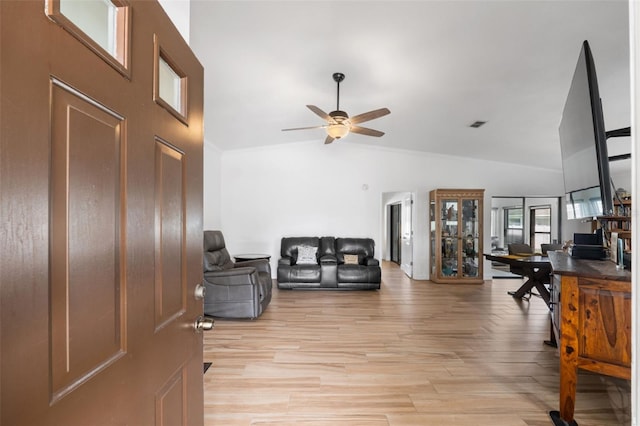 living room featuring crown molding, ceiling fan, high vaulted ceiling, and light hardwood / wood-style flooring