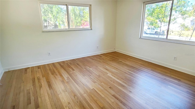 empty room with light hardwood / wood-style flooring