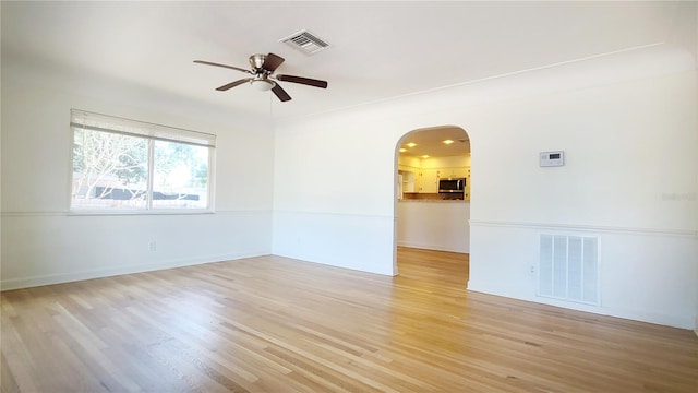 spare room featuring ceiling fan and light hardwood / wood-style flooring