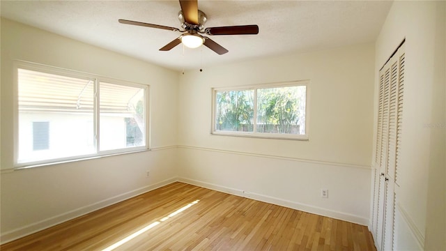 unfurnished bedroom featuring a closet, ceiling fan, and light wood-type flooring