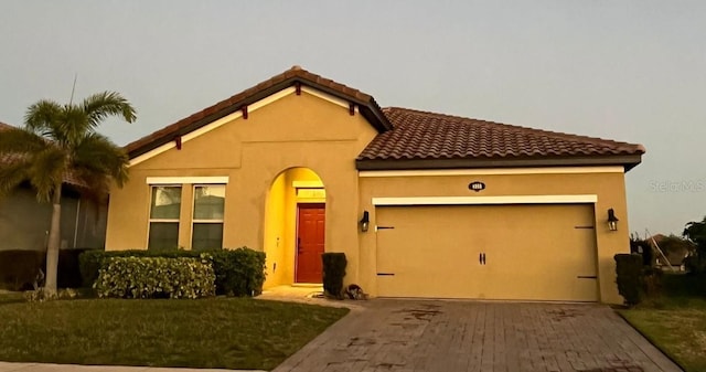 mediterranean / spanish-style home with a garage