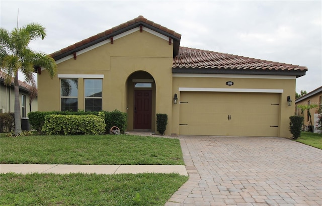 view of front of property featuring a garage and a front lawn