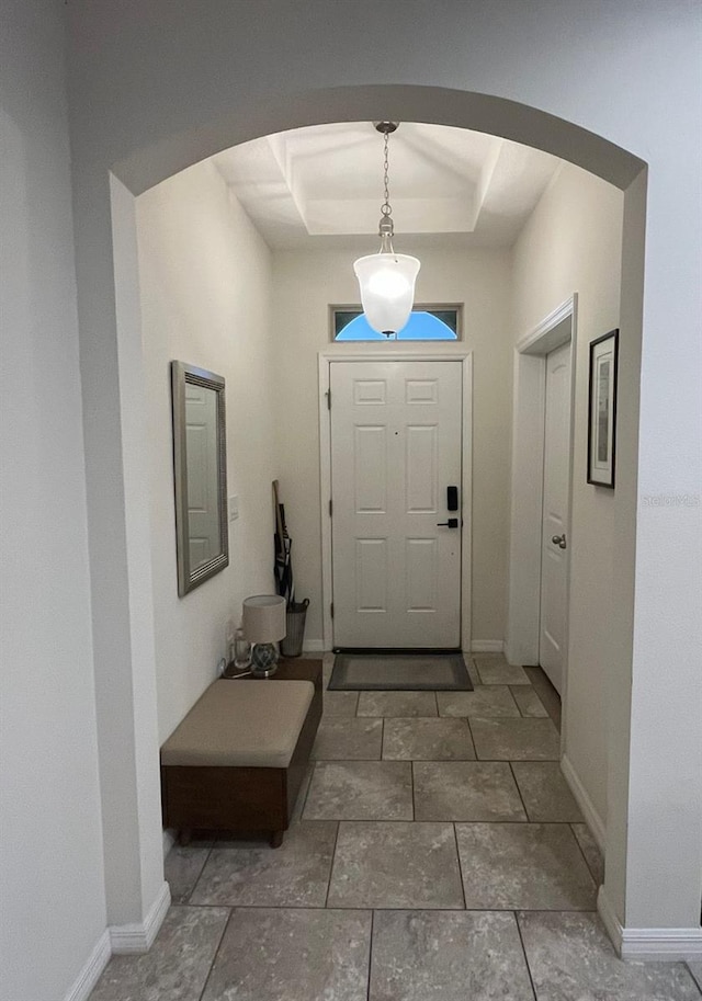 entrance foyer with a tray ceiling