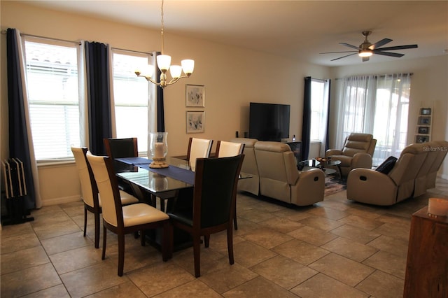 dining space featuring a healthy amount of sunlight and ceiling fan with notable chandelier