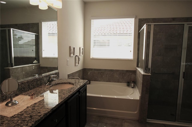 bathroom with vanity, separate shower and tub, and a wealth of natural light