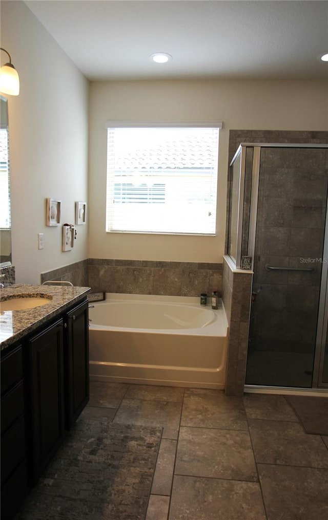 bathroom featuring independent shower and bath and vanity