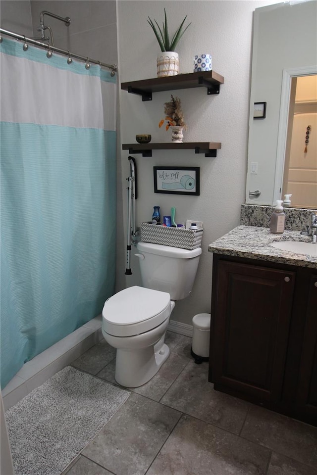 bathroom with vanity, toilet, and walk in shower