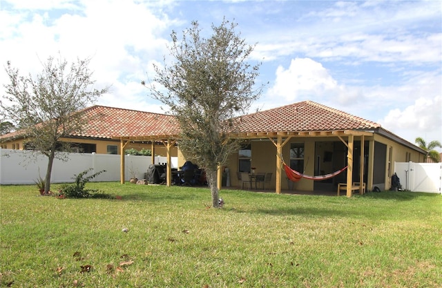 back of house with a yard and a patio area