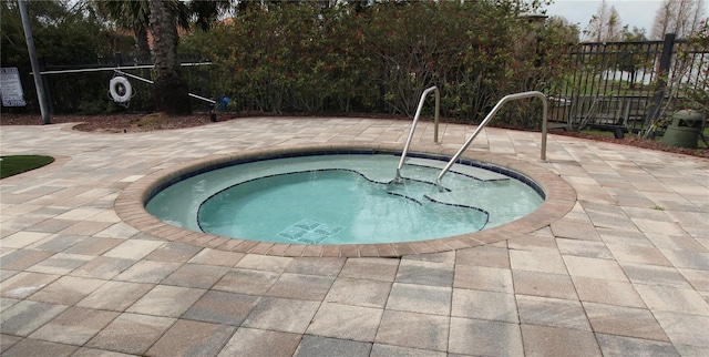 view of pool with a patio area and a community hot tub