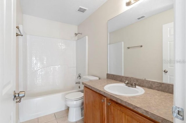 full bathroom featuring washtub / shower combination, tile patterned floors, toilet, and vanity