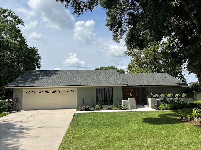 ranch-style home featuring a garage and a front yard