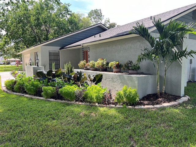 view of side of home featuring a lawn