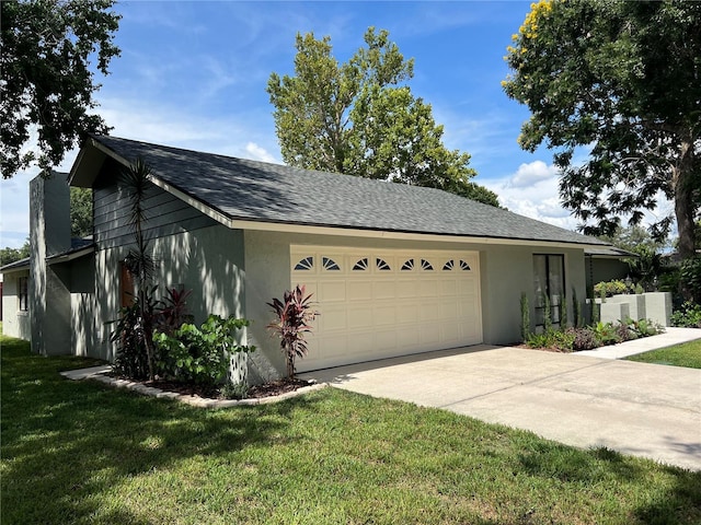 view of front of property featuring a garage and a front lawn