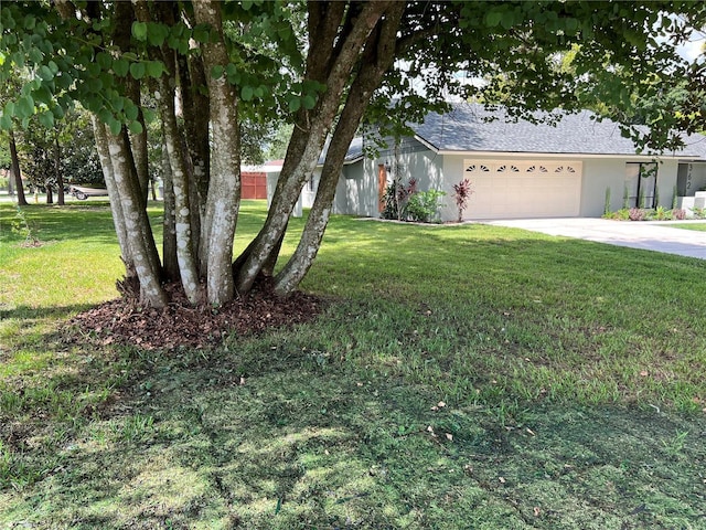 view of front of property with a garage and a front yard