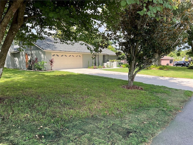 view of front of house featuring a garage and a front yard