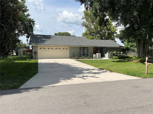 ranch-style home with a garage and a front yard