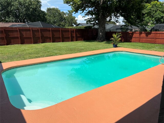 view of pool featuring a yard