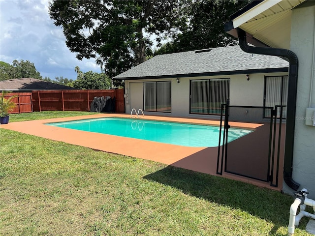 view of pool with a lawn