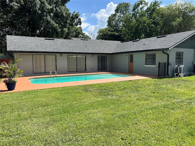 view of pool with a yard and a patio area