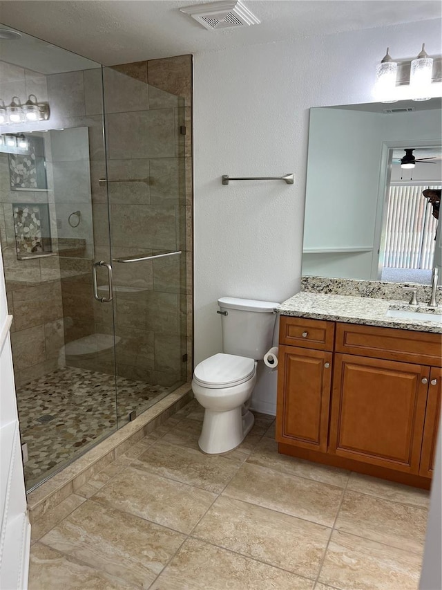 bathroom with vanity, toilet, and walk in shower